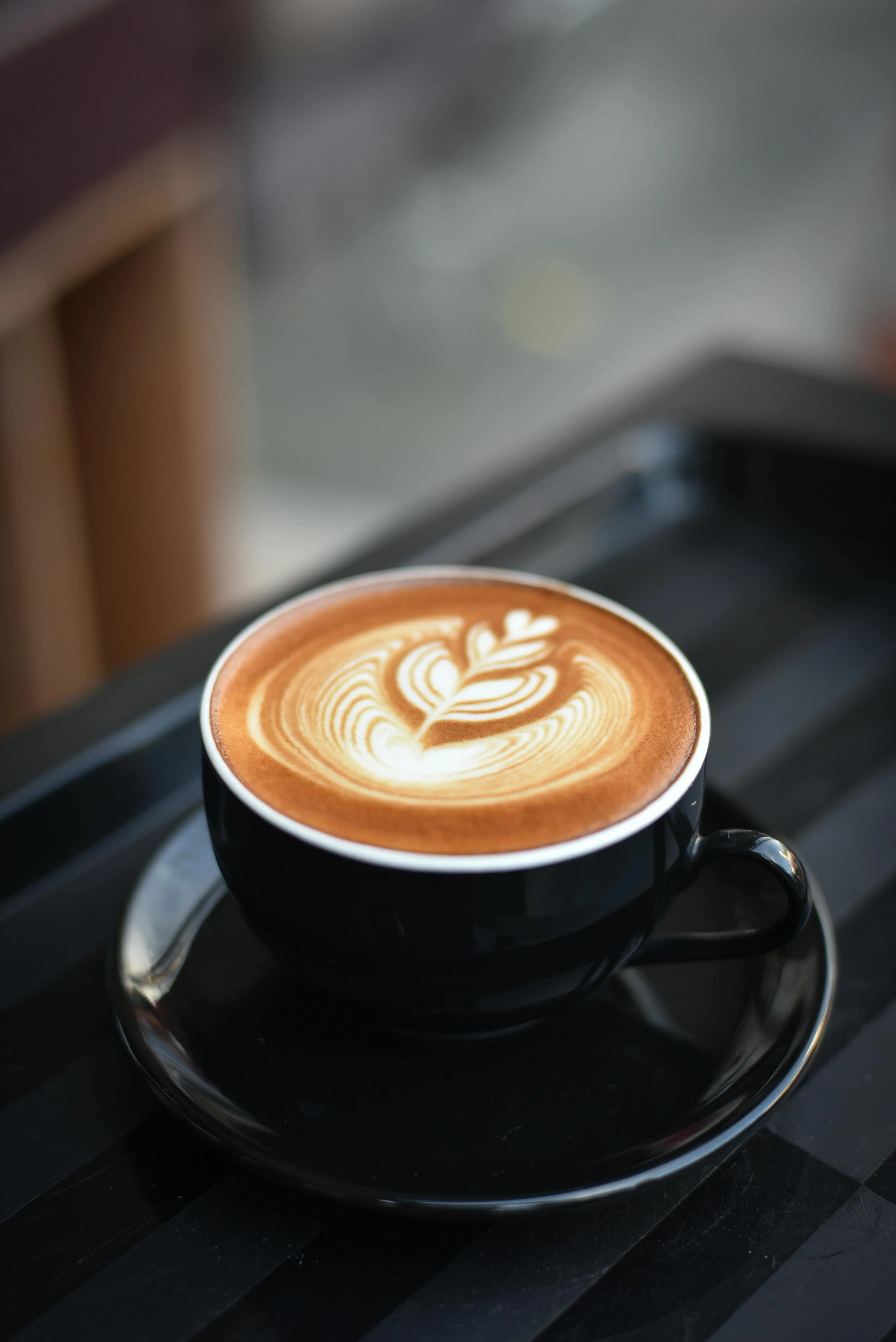 Cup of coffee with a leaf swirl in the middle